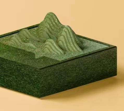 A 3D custom sculpted eco-friendly gift box designed with a layered green mountain landscape, made from sustainable tea pressed panel material.