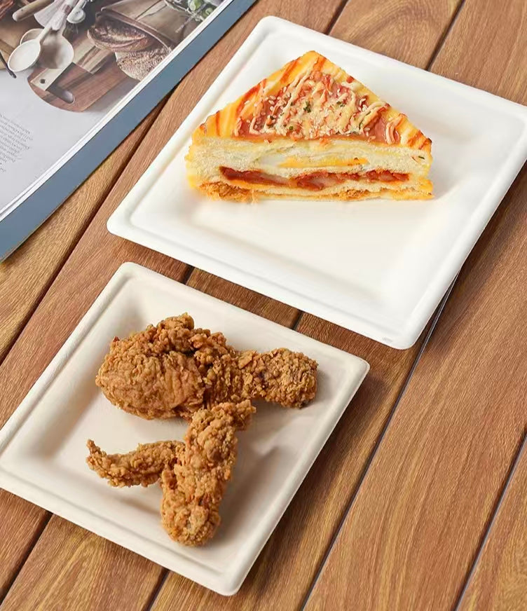 white square compostable plate with food, disposable sugarcane tray for takeout 
