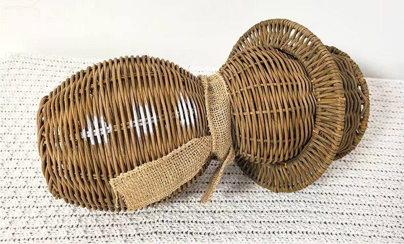 A standalone boho-style handwoven natural rattan snowman figurine featuring a top hat and rustic scarf for seasonal mantel and shelf styling.