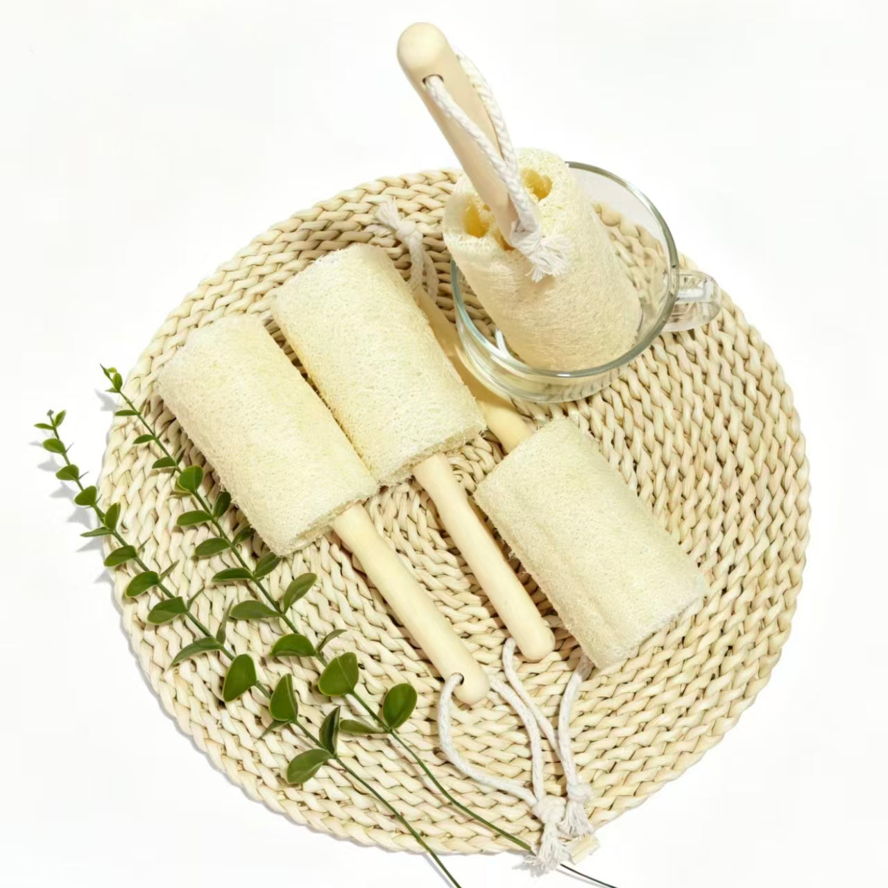 Eco friendly loofah cup brush placed on rattan mat, sustainable kitchen cleaning accessory
