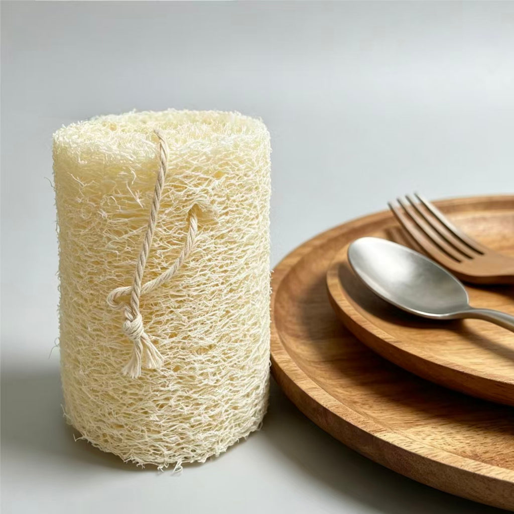 Natural loofah sponge placed with wooden tableware, eco friendly kitchen cleaning tool