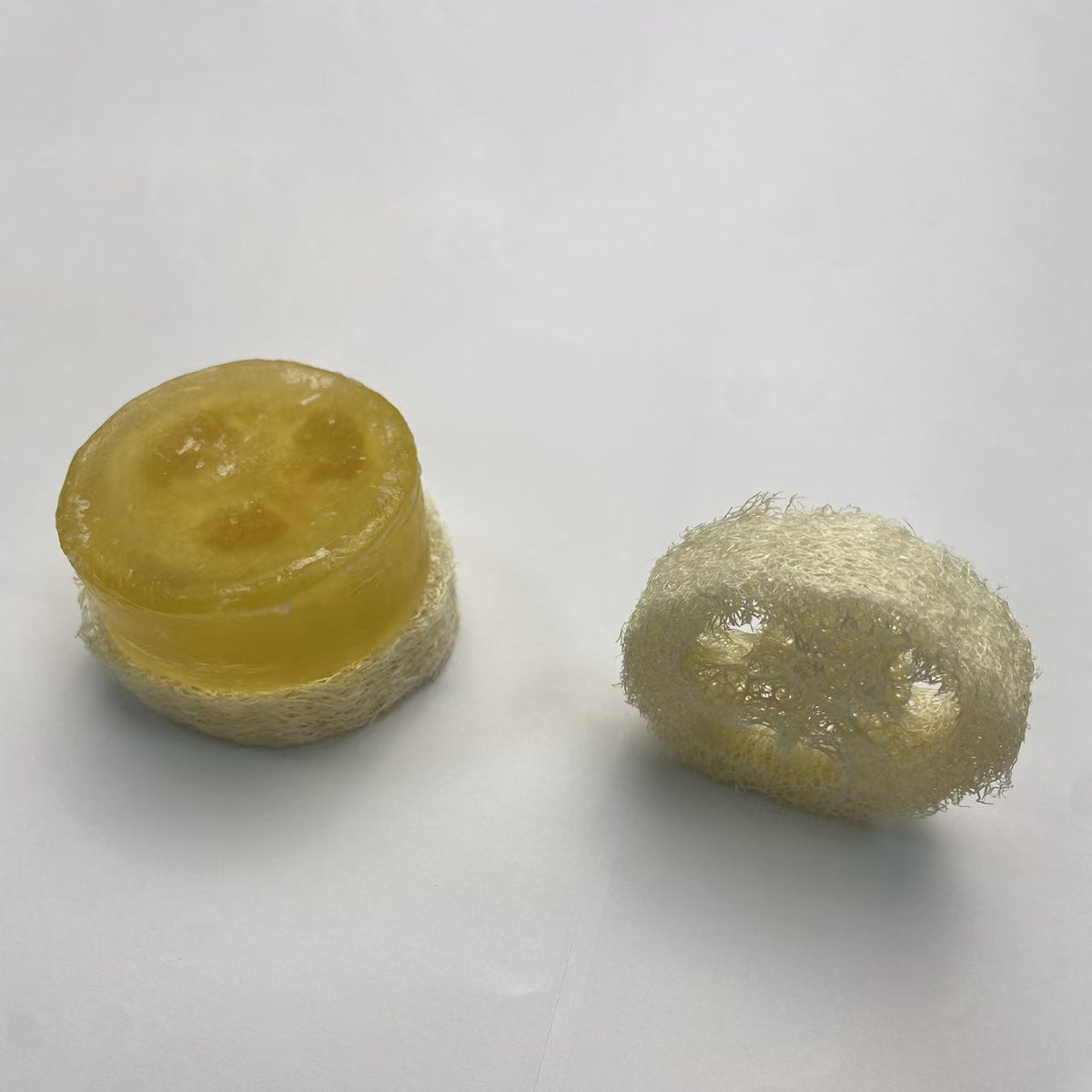 Natural loofah pad holding handmade soap, quick drain soap saver for shower