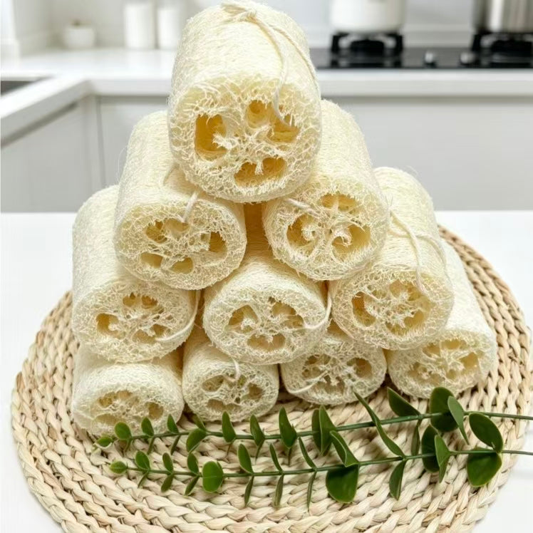 Stacked natural loofah dish scrubbers on kitchen counter, sustainable zero waste cleaning supplies