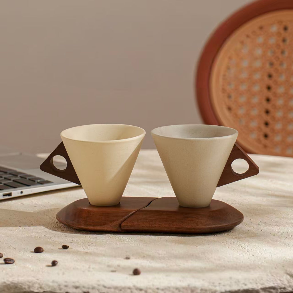 Two cone stoneware coffee cups with wooden handles and split stand, styled with coffee beans for home cafe decor