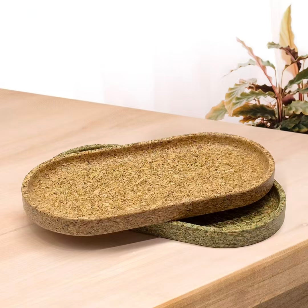 Stacked sustainable serving trays showcasing the organic tea-dregs texture and natural organic aesthetics.
