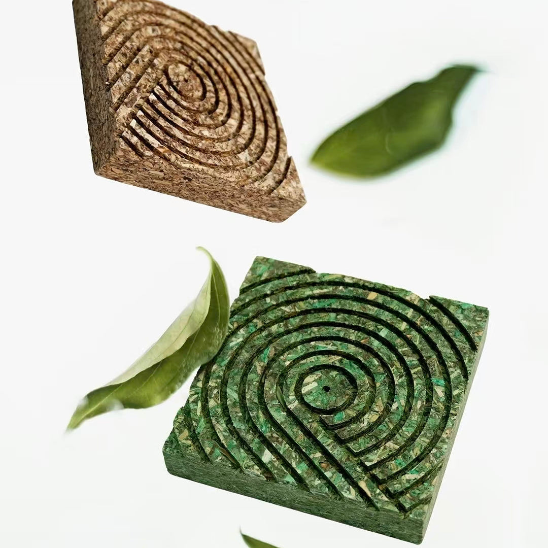 Upcycled green and brown tea fiber pressed panels floating with leaves on white background
