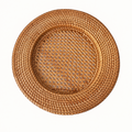 Handwoven round rattan charger plate with openwork weave center on white background by xuraneco