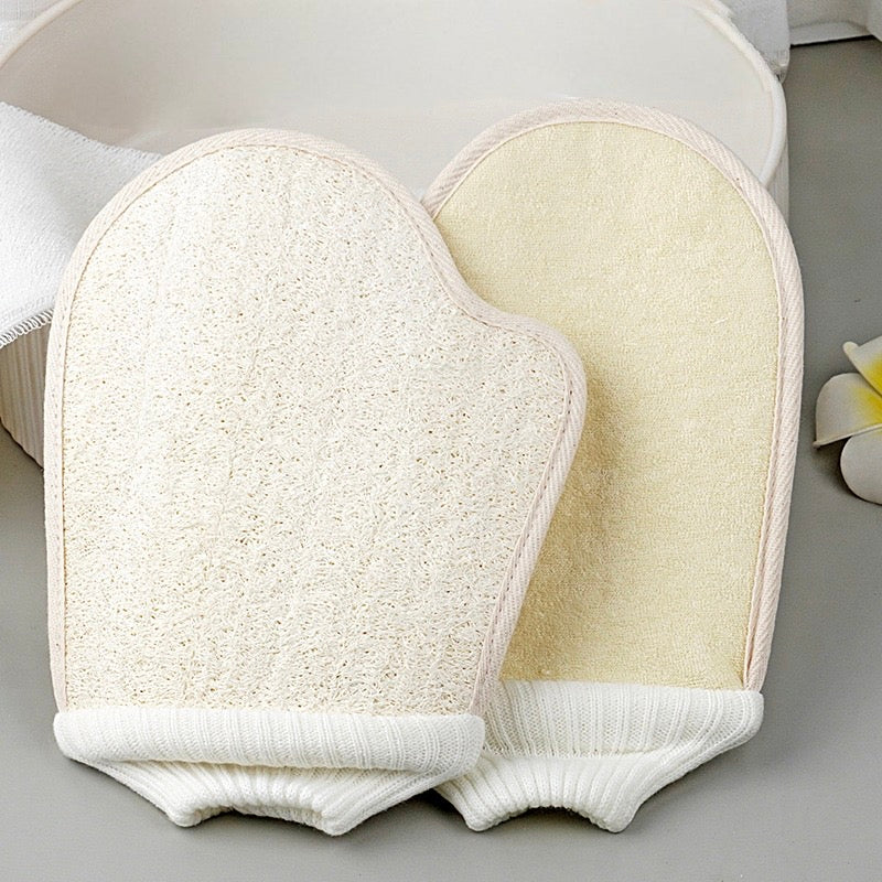 Two natural loofah exfoliating bath mitts showing textured and fabric sides