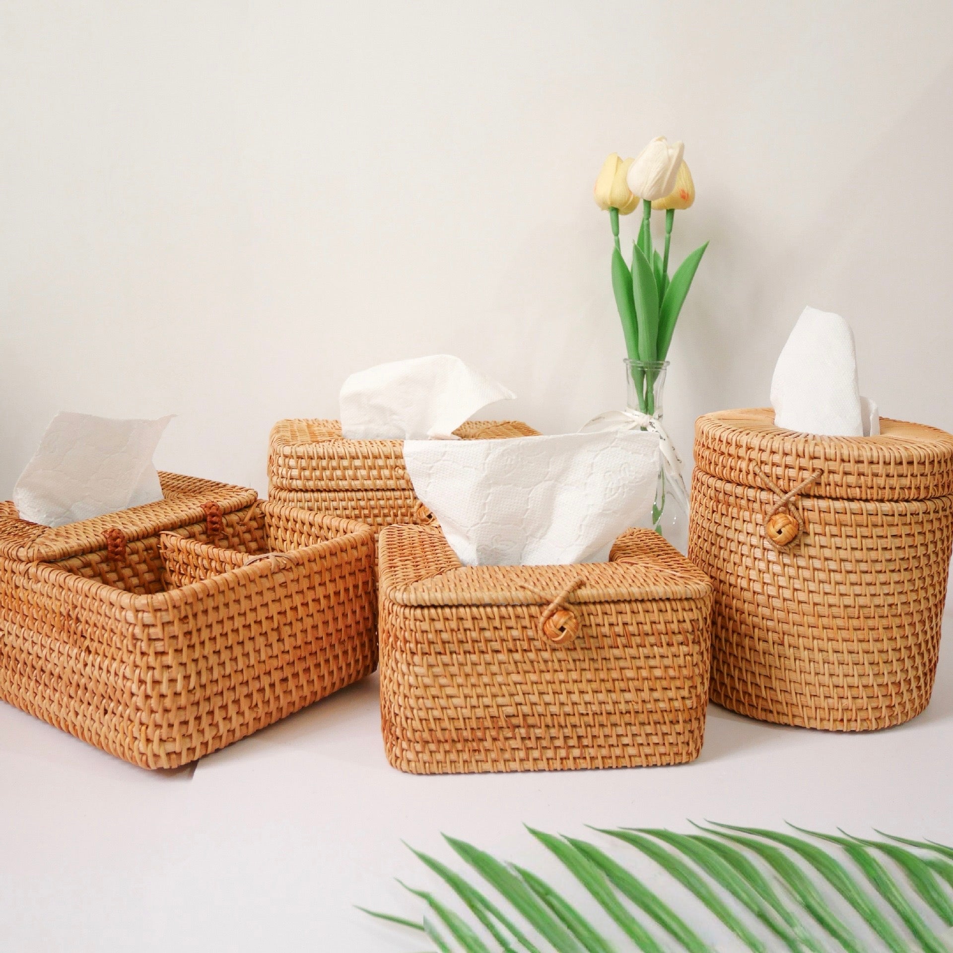 Four woven tissue holders in different shapes with tissues displayed