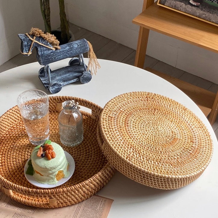 Round woven trays arranged on a table with drinks and dessert